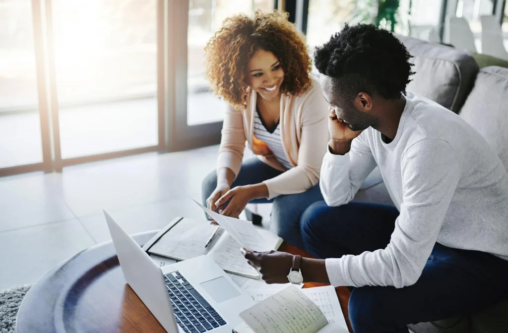 This is a photo of a black couple going over their plan on getting out of title loan debt