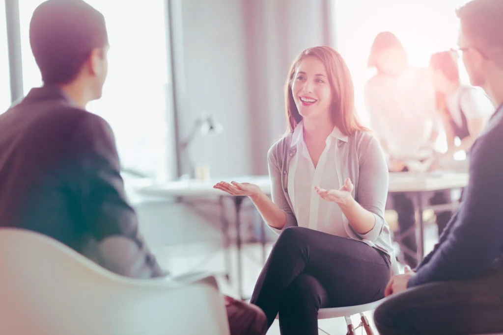 This is a photo ofa group of people in an office talking about the benefits of title loans