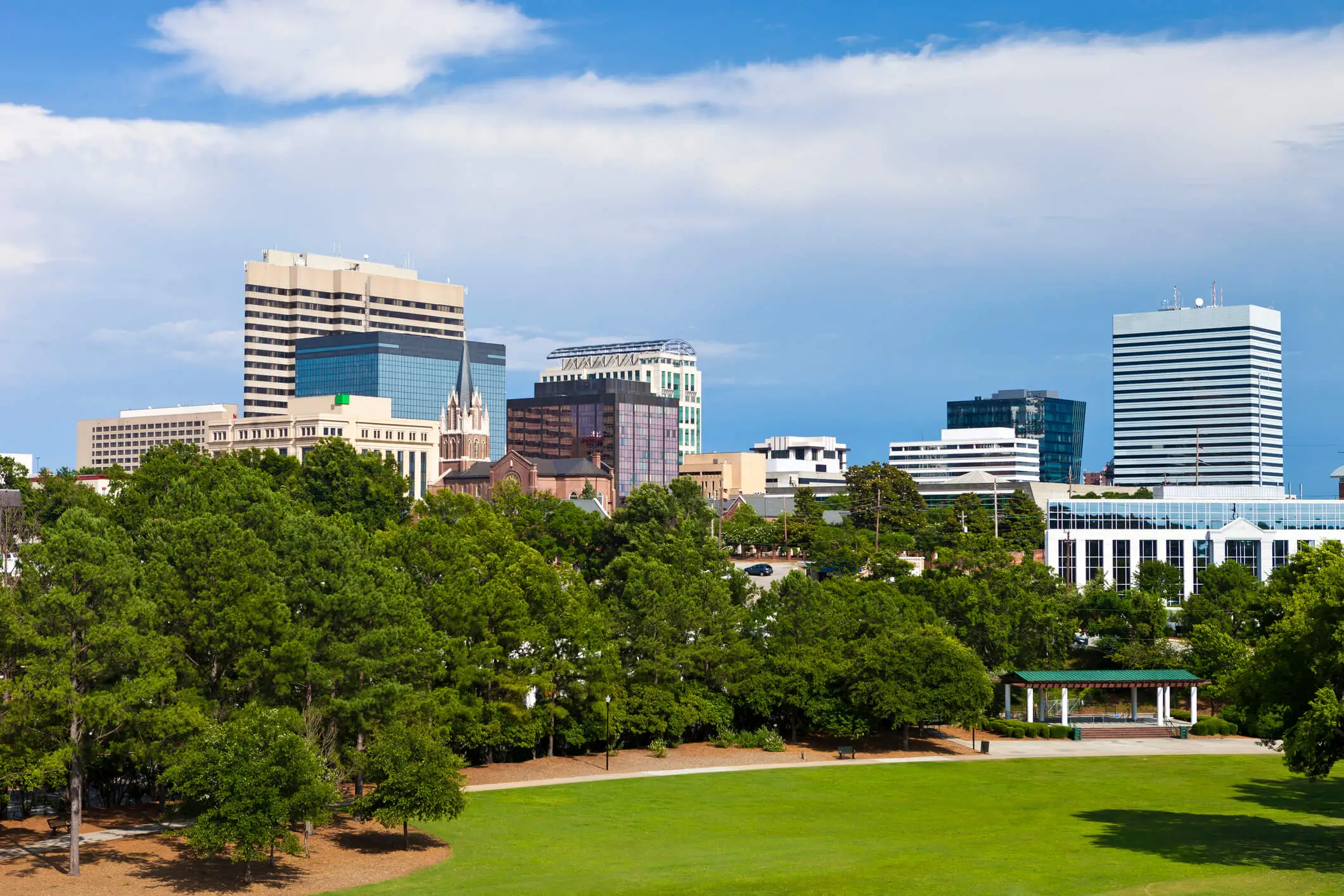 Photo of the Columbia South Carolina skyline showing all the buildings and skyrises on a nice summer day