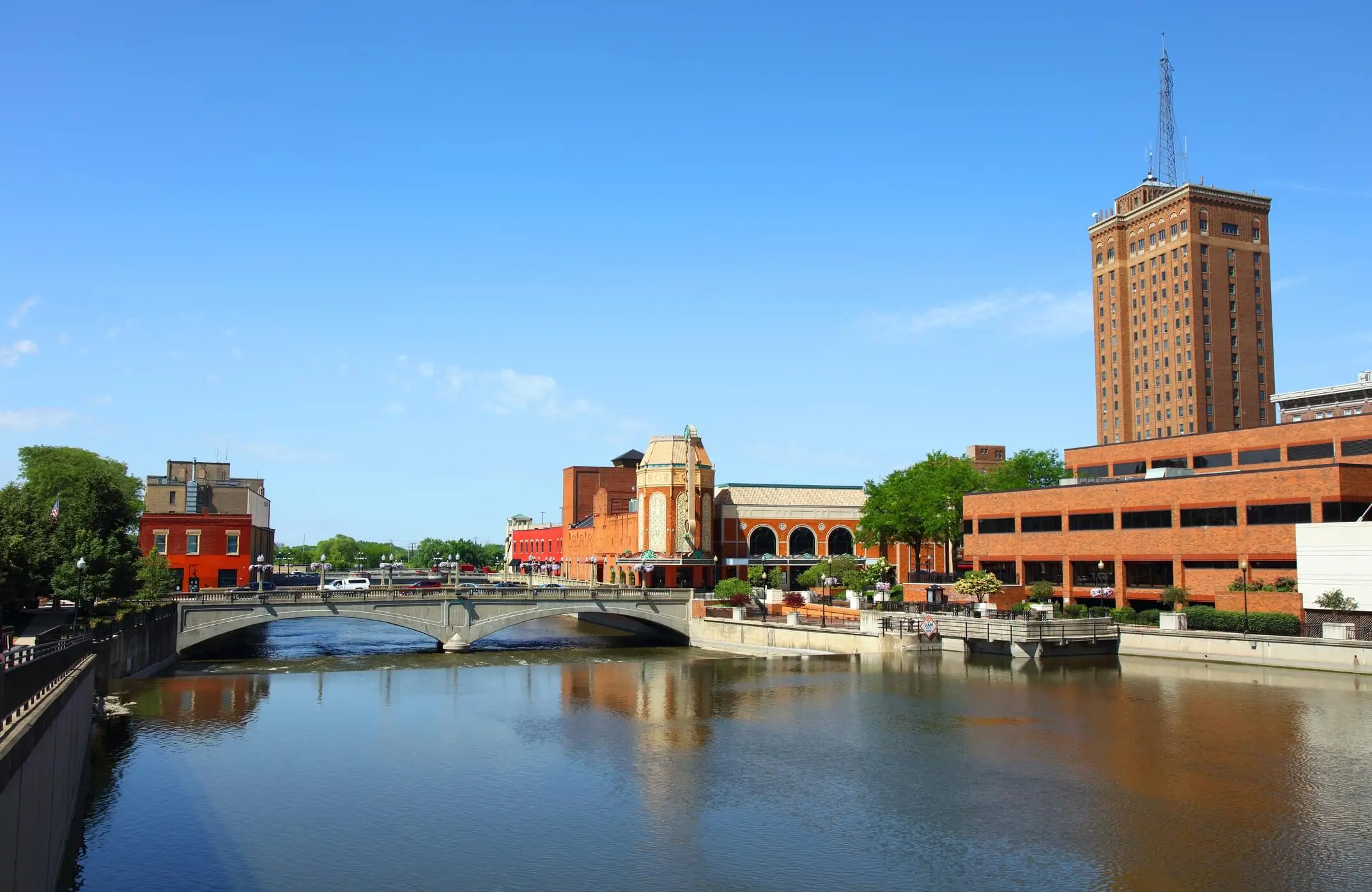 This is a photo of a river and a building in downtown Aurora Illinois